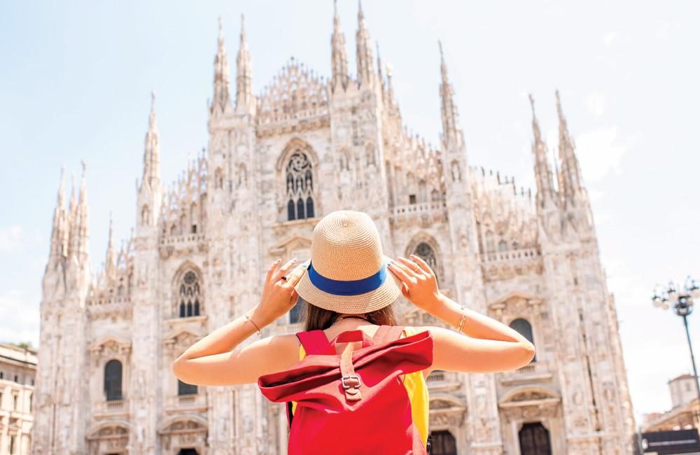 A female facing the Milan Cathedral.