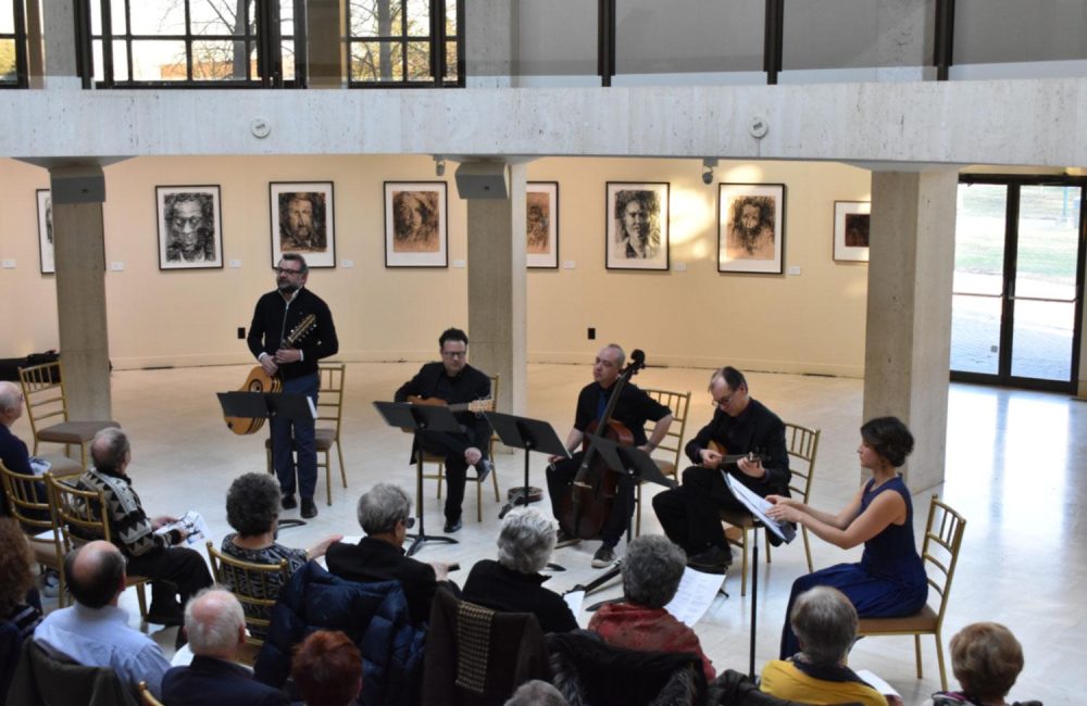 A group of musicians performing to a crowd at the Columbus Centre.